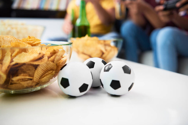 Detail of balls and potato chips on the table - Photo, Image