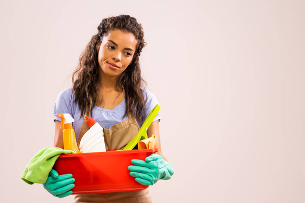Portrait of african-american professional maid who is tired of cleaning. - Photo, Image