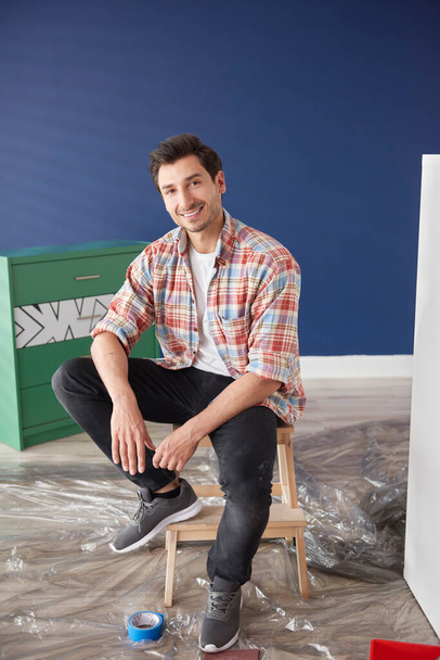Portrait of man repainting a house - Фото, изображение