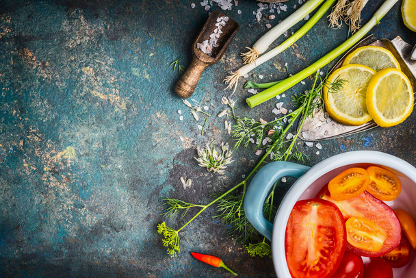 Healthy vegetarian eating and cooking with fresh organic vegetables and seasoning ingredients on dark rustic background, top view - Fotoğraf, Görsel