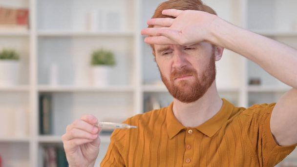 Portrait of Sick Redhead Man Checking Temperature by Thermometer  - Foto, imagen