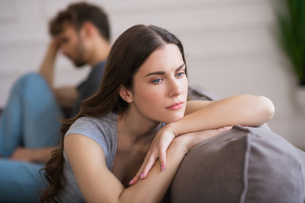 Young woman sit looking upset after a bad talk with her husband - Foto, Imagem