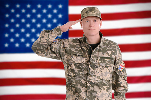 Male soldier and American flag on background. Military service - Photo, Image