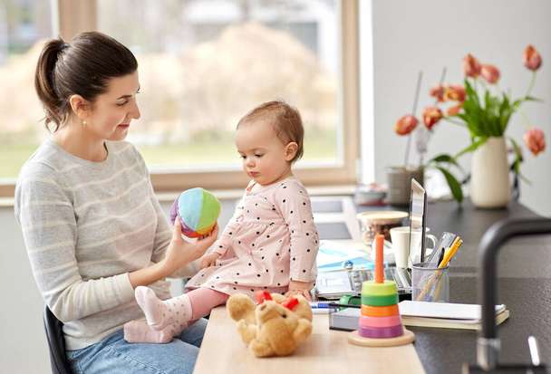 happy mother with baby working at home office - Photo, image