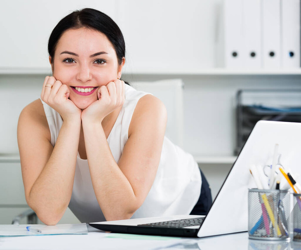 Young woman worker posing gracefully while working in office - Foto, immagini