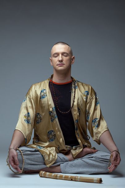 Image of yoga guru meditates in studio - Fotoğraf, Görsel