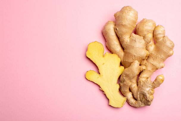 Trendy food flat lay concept on light pink background with fresh big ginger root close up copy space isolated - Photo, Image