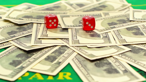 red dice falling on dollar banknotes, online betting concept  - Footage, Video