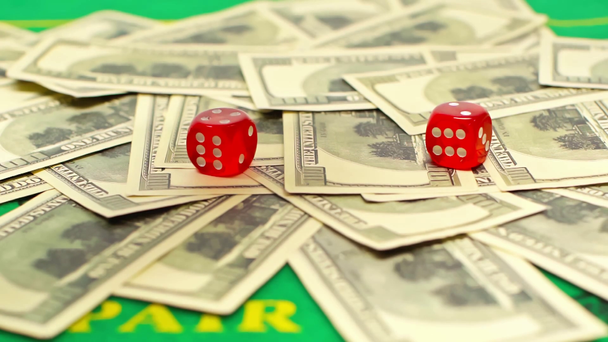 ドル紙幣に落ちるダイスの遅い動き、オンライン賭けの概念  - 映像、動画