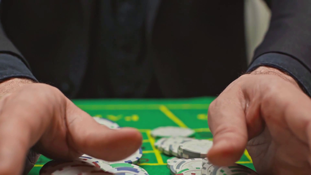 Slow-motion of player pulling all poker chips on poker table  - Video, Çekim