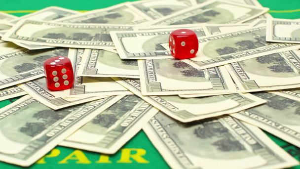 dice falling on dollar banknotes, online betting concept  - Footage, Video