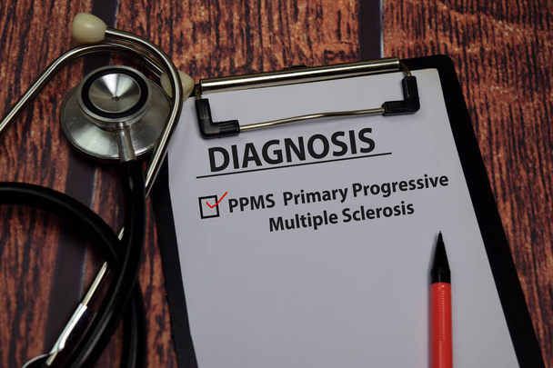 Diagnosis - PPMS. Primary Progressive Multiple Sclerosis write on paperwork isolated on wooden table. - Fotoğraf, Görsel