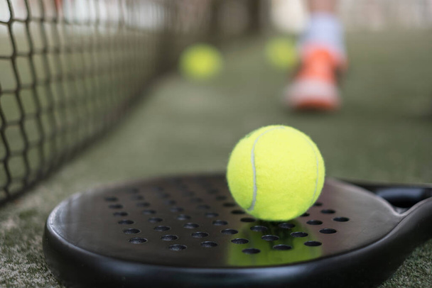 Paddle tennis racket and balls on court still life - Fotó, kép