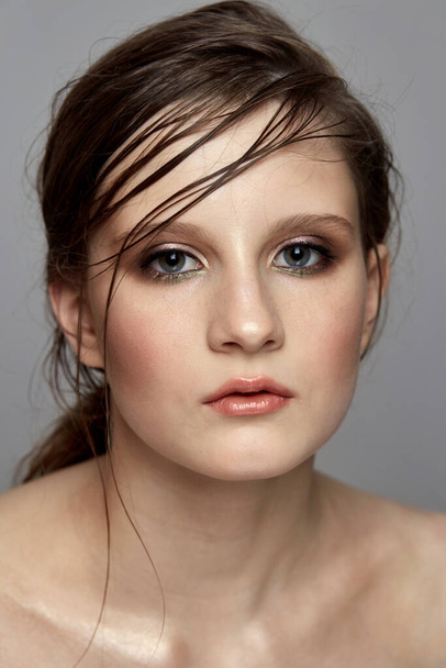 Fashionable make-up on the face of a young brunette girl. - Photo, image