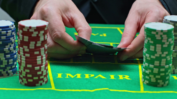 cropped view of player putting playing cards near poker chips  - Footage, Video