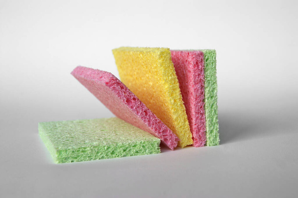 Bright colored sponges for washing dishes, cleaning the bathroom and other household needs. Close-up - Фото, изображение