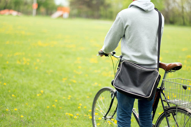 young woman with bicycle in park - Foto, Bild