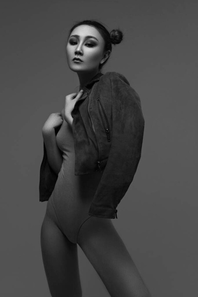 Pretty young sexy fashion sensual woman dress in jacket posing on studio - Photo, image