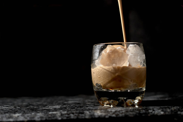 iced coffee in glass bottom with black background - Photo, Image