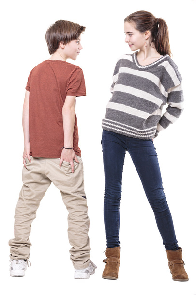 two teenager, male and female smiling at each other, isolated on - 写真・画像