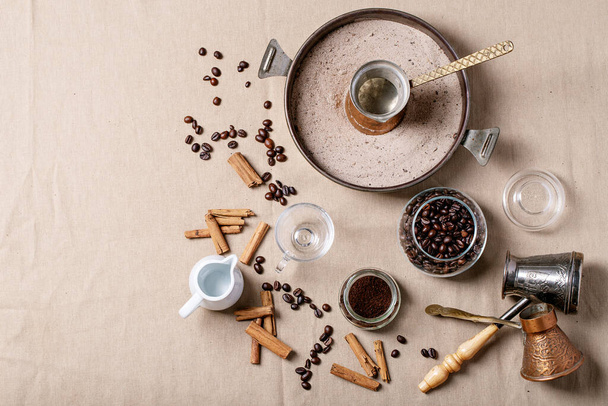 Fresh coffee beans in glass jar over textile cloth brown background. Top view, flat lay - Foto, afbeelding