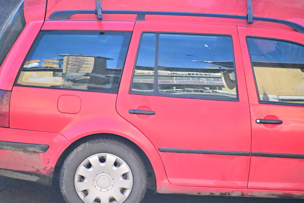 Cropped section of red car parked outdoors - Photo, Image