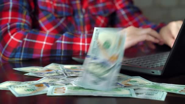 Cash money falling on table of employee using laptop in office - 映像、動画