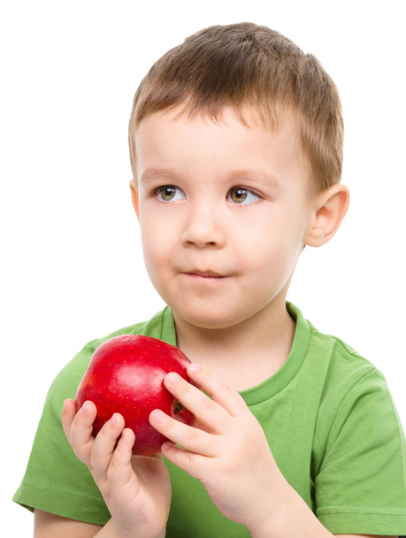 Portrait of a cute little boy with red apple - Фото, зображення