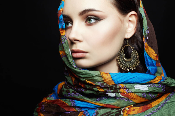 beautiful young woman in color veil and jewelry. beauty girl in colorful hijab. fashion oriental woman - Foto, afbeelding