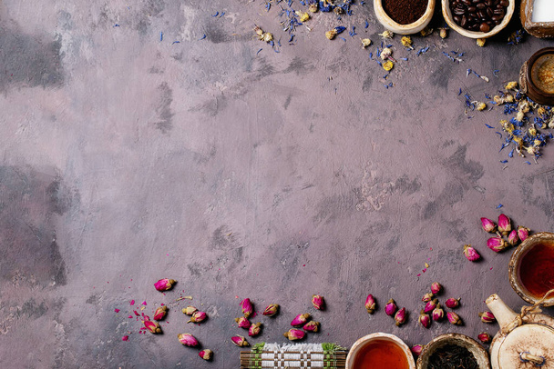Black tea in a ceramic cup versus espresso coffee over a brown texture background. Top view. Copy Space - 写真・画像