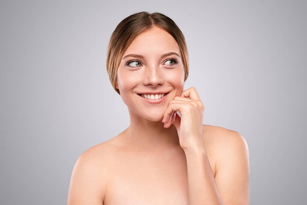 Cheerful woman with clean skin looking away - Photo, Image