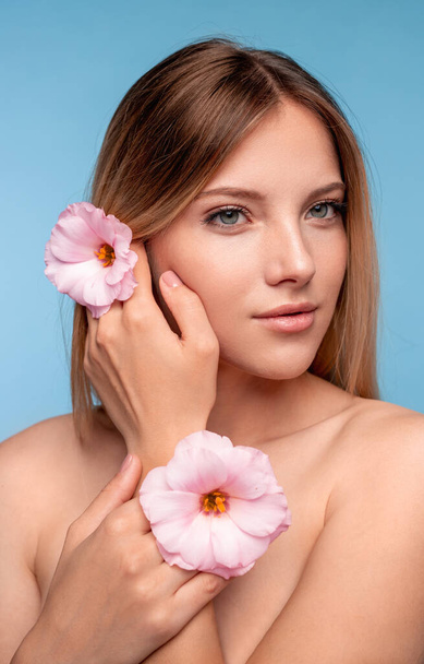 Pretty female decorating hair with flowers - Photo, Image