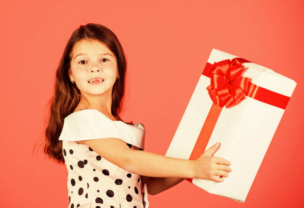 This is for you. little girl carry present. big christmas sale. kid hold gift box. boxing day concept. dreams come true. happy new year. winter holiday and xmas joy. seasonal shopping discount - Foto, Imagen