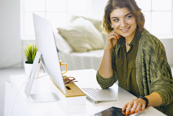 Young woman working with graphic tablet in office - Foto, immagini
