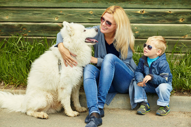 outdoor portrait mother, son and dog. child and mom walking samoyed laika. - 写真・画像