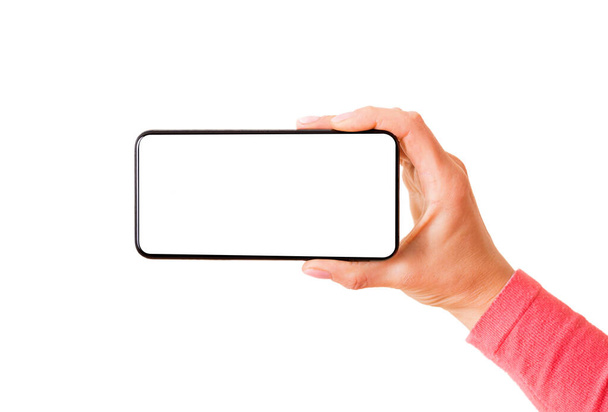 Person hält Smartphone mit leerem weißen Bildschirm horizontal, Foto isoliert auf weißem Hintergrund - Foto, Bild