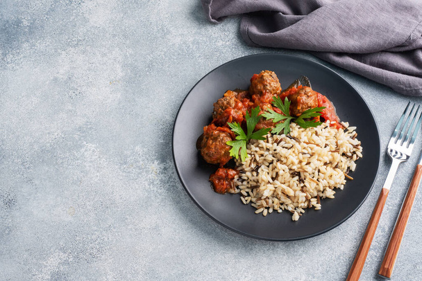 Beef meatballs and brown rice on a plate. Ready made portioned dish meat with garnish Copy space. - 写真・画像