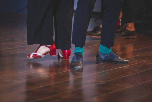 Dancing shoes of young couple dance retro jazz swing dances on a ballroom club wooden floor, close up view of shoes, female and male, dance lessons - Photo, image