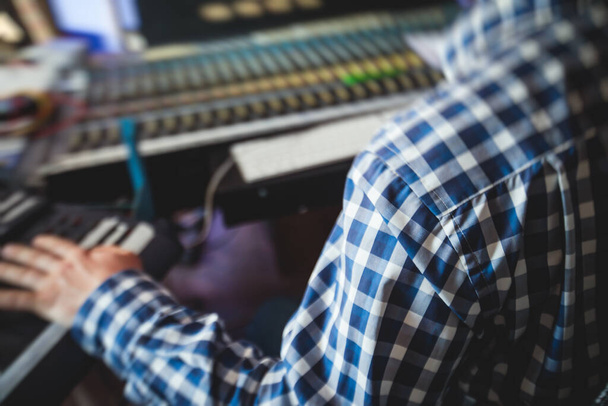 Sound editor engineer working at studio with mixing panel, mixing music and sound, stage sound mixer, boutique recording studio, working during concert performance recording, broadcasting studio - Foto, immagini