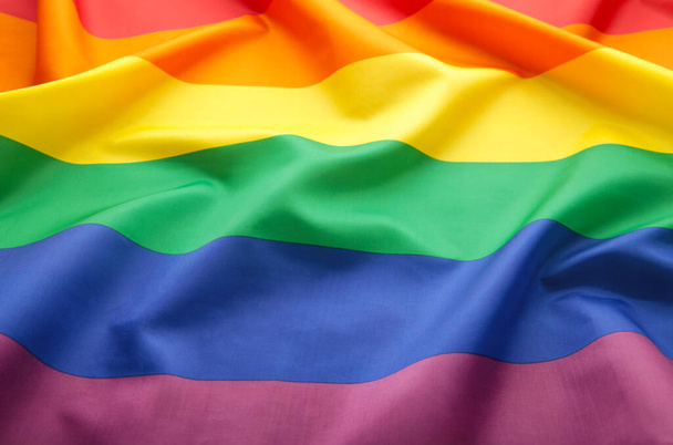 A rainbow flag background. LGBT, top view - Foto, Bild