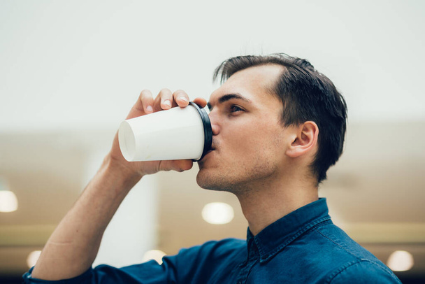attractive young man with a coffee to take away - Photo, Image