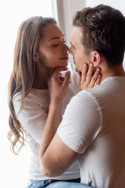 handsome man touching face of beautiful woman at home  - Fotoğraf, Görsel
