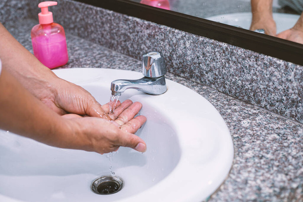 A man's hand is washing and cleaning hands - 写真・画像
