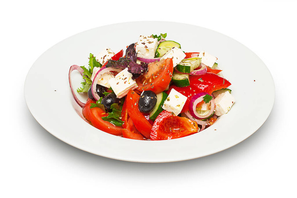 Salad with cheese and fresh vegetables isolated on white background. Greek salad. - Fotó, kép