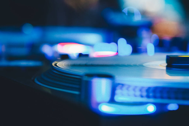 DJ vinyl players in dark nightclub, party in the dance club, DJ equipment, defocused  - Foto, afbeelding
