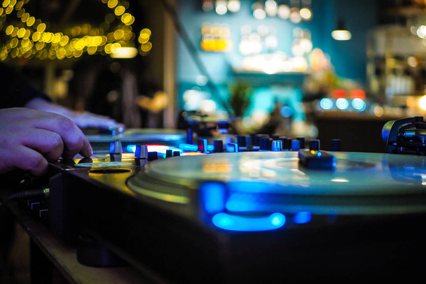 DJ vinyl players in dark nightclub, party in the dance club, DJ equipment, defocused  - Photo, Image