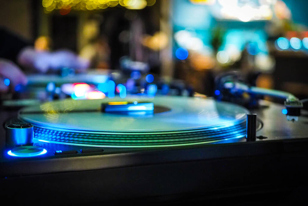 DJ vinyl players in dark nightclub, party in the dance club, DJ equipment, defocused  - Фото, зображення