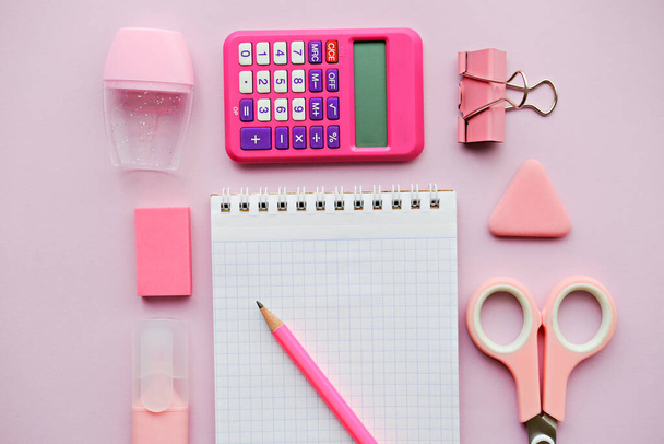 Pink girlish school supplies, notebooks and pens on pink background. Top view, flat lay. Copy space. Back to school. - Foto, Bild