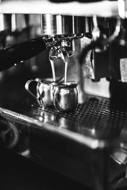 coffee machine in the cafe pouring coffee - 写真・画像