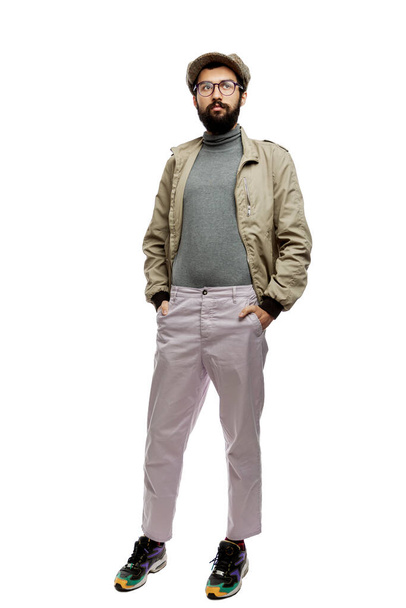 Stylish young man with a beard and a cap. Full height. Isolated on a white background. Vertical. - 写真・画像